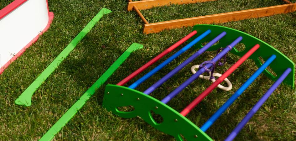 Small colorful ladder and a wooden ladder lying on the grass