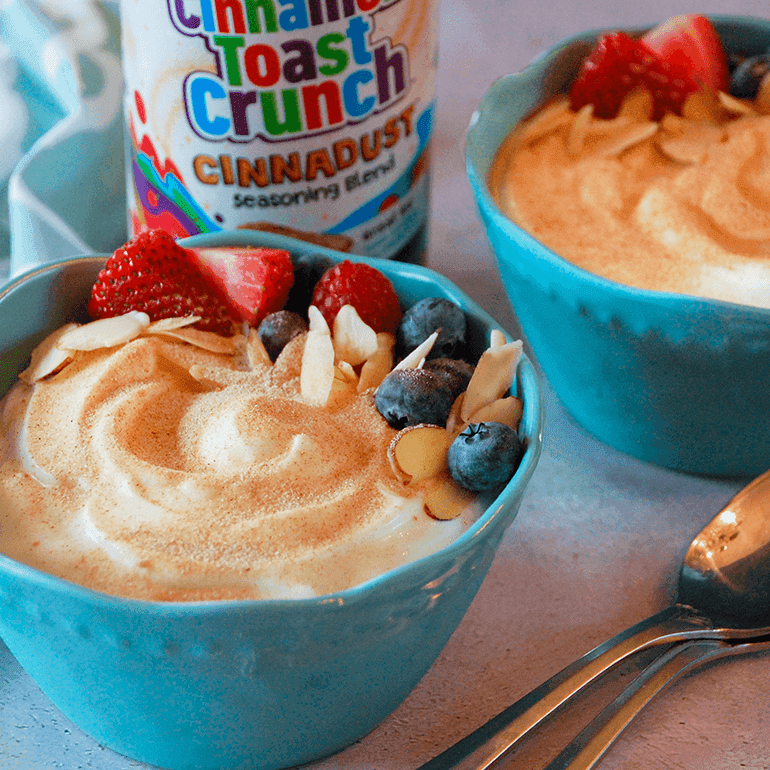2 Cinnadust™ Fruit, Nut & Yogurt Bowls with a jar of Cinnadust™ between them.